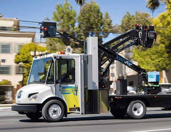 In San Jose, an electric tow truck navigates city streets efficiently, supported by advanced technology and local news highlighting industry innovations and community involvement.